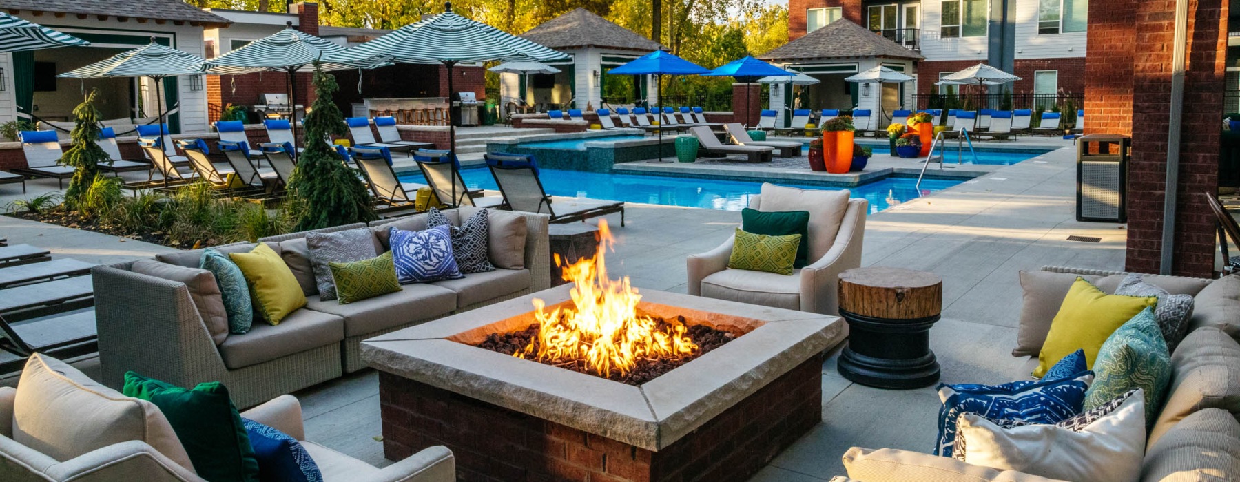 a pool deck with a fire pit